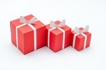 Three miniature red gift boxes on the white background