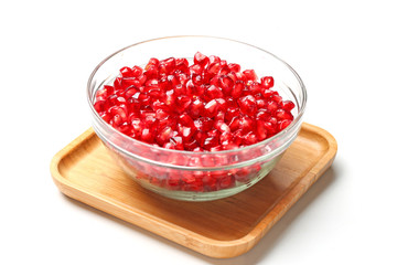 pomegranate seeds in glass bowl isolated on white background
