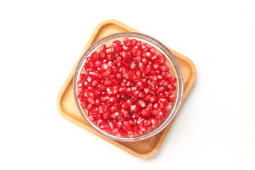 pomegranate seeds in glass bowl isolated on white background