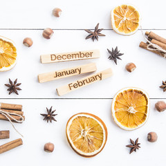 winter still life with the inscriptions of the names of the months - December, January, February among the Christmas products and ornaments. Flat lay