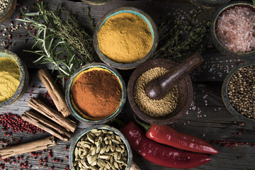 Spices and herbs in wooden bowls. Food and cuisine ingredients