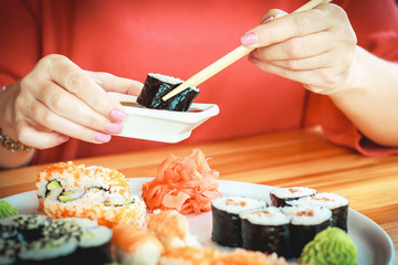 The best sushi rolls, Japanese cuisine. Different delicious kinds of sushi rolls. Cooking. The hand...