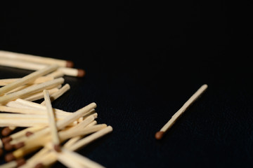 Scattered matches on dark background close up