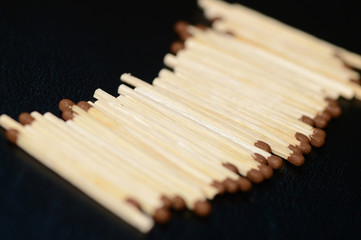 Scattered matches on dark background close up
