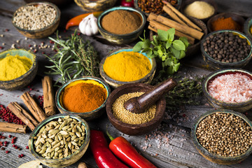 Spices and herbs in wooden bowls. Food and cuisine ingredients
