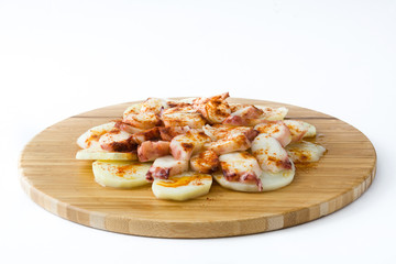 Pulpo a la gallega. Galician octopus on wood. Typical spanish food isolated on white background
