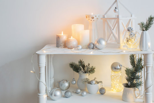 Christmas decoration with candles on background  white wall