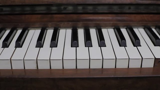 Slow tracking shot close up piano bass clef keys