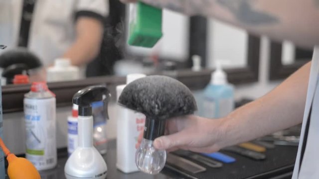 Barbershop dust. Powder in the hands of a man.