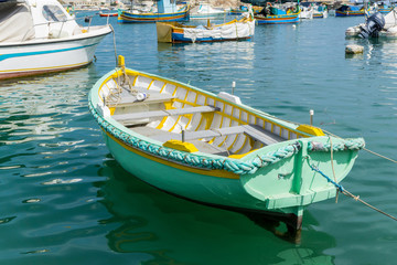Fototapeta na wymiar Traditional boats at Marsaxlokk Harbor in Malta