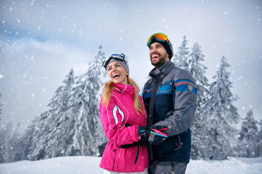 Beautiful smiling couple enjoying in winter vacations