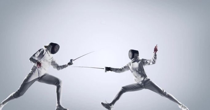 Two fencing sportswomen  in action on white background