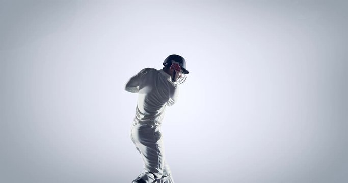 Cricket player in action on white background
