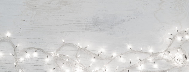 Chrsitmas or New Year ornamet led string lights on vintage wooden background