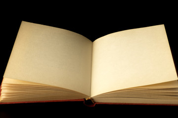 An open book on a black background