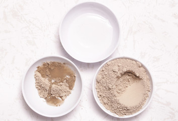 Obraz na płótnie Canvas Clay powder and water - facial mask ingredients