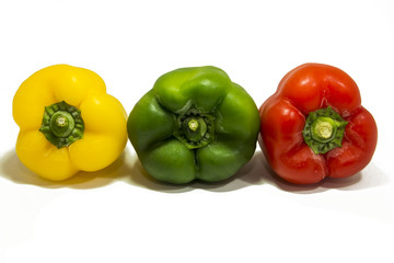 Yellow, green and red peppers isolated on white background