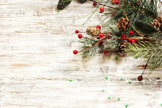 Christmas background with fir branches on festive White rustic wooden background