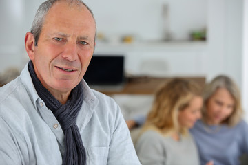 Obraz premium Portrait of senior man with his family in background