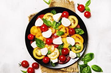 Salad caprese on gray background, top view