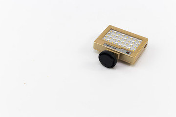 The small LED light in gold box with black stand leg