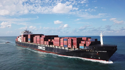 Huge large mega ULCV container ship sails on open water fully loaded with containers and cargo -...