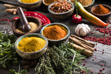 Herbs and spices on a wooden background 