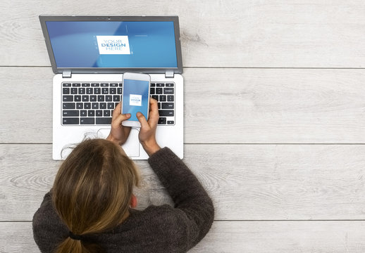 Young Smartphone User Laying on Floor with Laptop Mockup