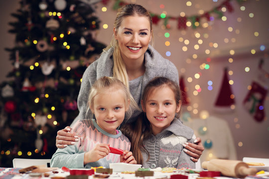 Joyful family preparing Christmas biscuits