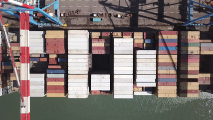 underway - LARGE container ship fully loaded with containers and cargo - aerial 4k view top down