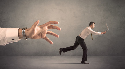 Businessman running from hand