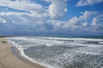 Fototapeta na wymiar Partly cloudy on the sandy coast