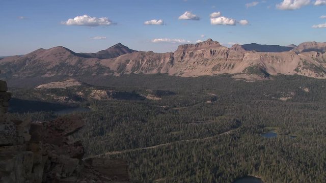Panning view of mountain range in the Uintas near by Mirror Lake.