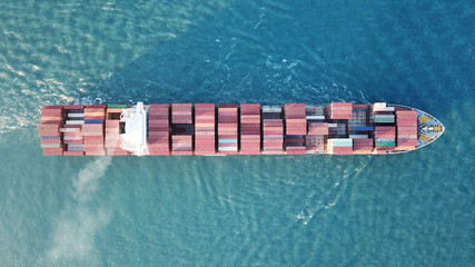 underway - LARGE container ship fully loaded with containers and cargo - aerial 4k view top down