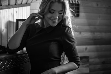 Elegant young beauty woman in interior black-white portrait.