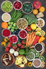 Large health food collection with fruit, vegetables with spices and herbs also used in natural herbal medicine. Superfoods concept with foods high anthocyanins, fiber, antioxidants and vitamins.