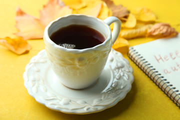 A cup of tea and autumn leaves