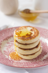 Cottage cheese pancakes, homemade syrniki with honey and sour cream.