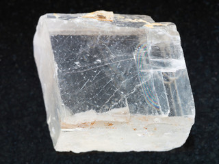 rough crystal of Iceland spar gemstone on dark