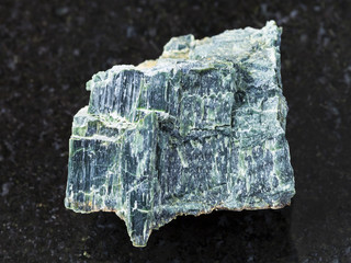 rough chrysotile asbestos stone on dark