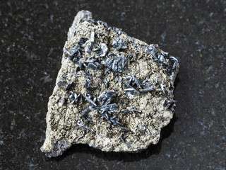 magnetite crystals on rough stone on dark