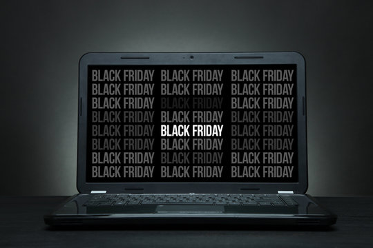  laptop is on a black desk