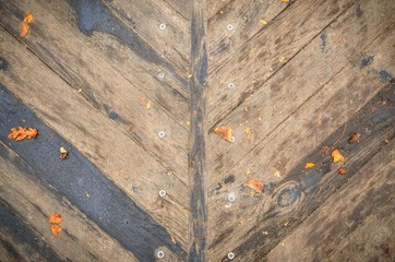 Brown wooden background. Natural planks with autumn leaves.