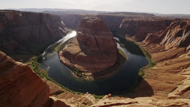 Wide high angle flyover shot of river bend in canyon / Page, Arizona, United States