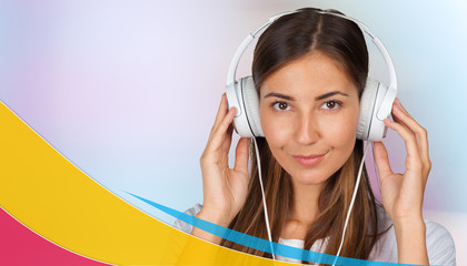 Portrait of young woman listening to music in earphones