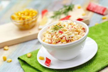 Salad with crab sticks and sweet corn in a bowl