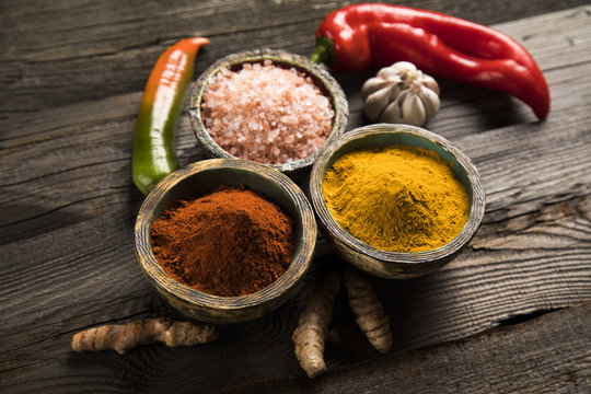 Spices on wooden bowl background 