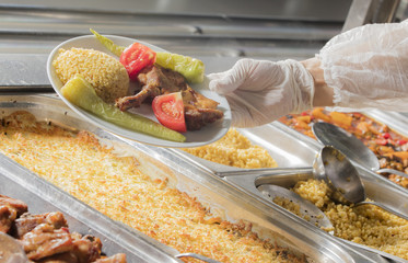 chef standing behind full lunch service station