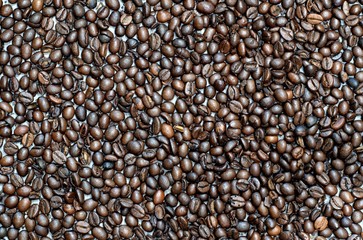 Background of brown coffee beans.Coffee beans on a wooden background.