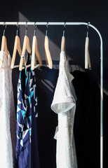 elegant dress hanging on rack in bedroom 